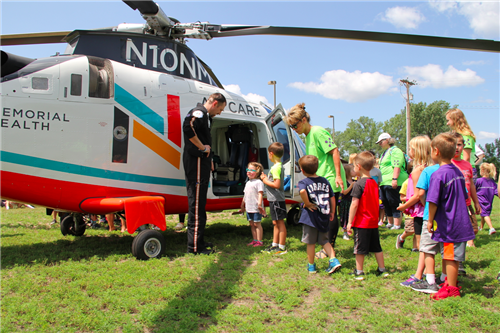 Adventures Plus students get close up look at Air Care Helicopter while learning about community helpers 